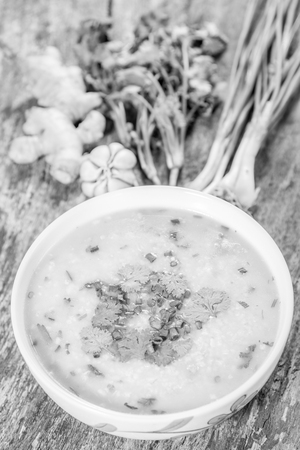Traditiona porridge rice gruel in bowl on wooden background , black and whiteの写真素材