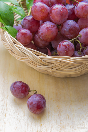 purple round grapes on old wooden table