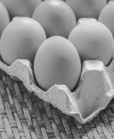 Close of package with eggs , black and white