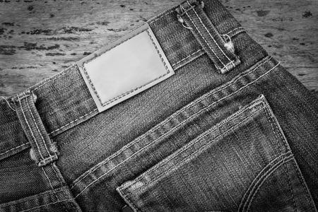 Leather jeans label sewed on blue jeans, black and whiteの写真素材
