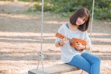 Young woman playing on Ukuleleの写真素材