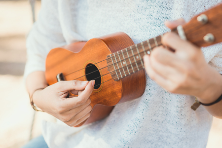 Young woman playing on Ukuleleの写真素材