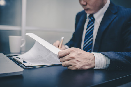 Business man signing a contract. Close-up photo , vintage toneの写真素材