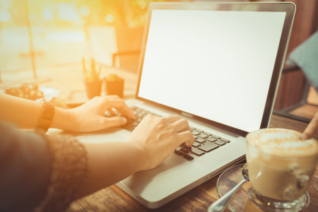 young woman using laptop at coffee shop. vintage toneの写真素材