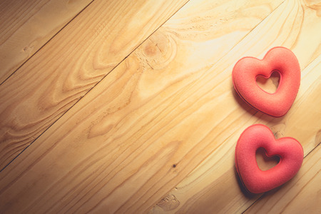 Valentines Day background with hearts on old wooden, vintage toneの写真素材