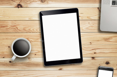 Tablet, laptop, coffee cup and smartphone on wood table.の写真素材