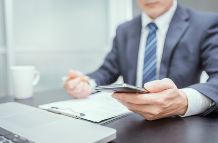 Businessman hand using mobile phoneの写真素材