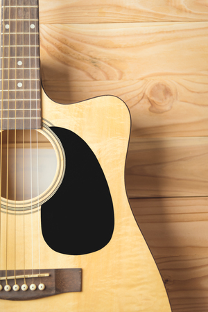 Acoustic guitar on wood backgroundの写真素材