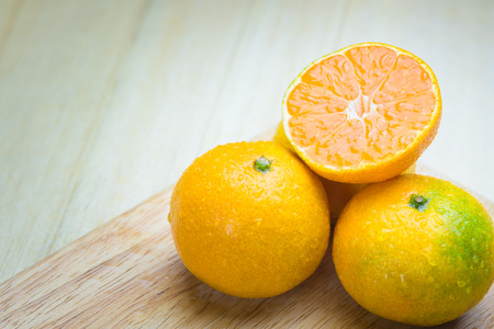 Oranges isolated cut set on wooden baseの写真素材