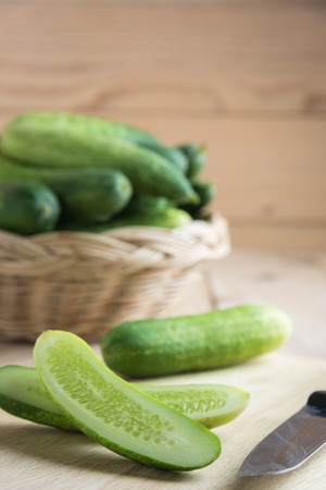 Fresh cucumber and slices on wooden tableの写真素材