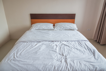 Stylish white bedroom with a white bedの写真素材