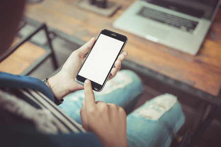 Hand holding smartphone white screen ,  vintage toneの写真素材
