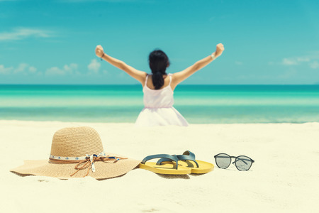 Shoes glasses and hat on the beach. The white sand beaches from Thailand. Yellow shoes, Brown hat, Riksdag black goggles on the beach. vintage toneの写真素材