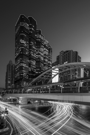 Public sky-walk at sky-train station 'Chong Nonsi' in Bangkok downtown square at night, Bangkok, Thailand.の写真素材