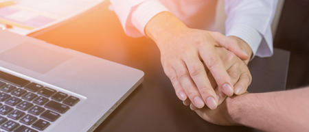 doctor's hands holding  patient's hand for encouragement and empathyの写真素材