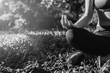 Yoga in the park, outdoor with effect light, health woman, Yoga woman. Concept of healthy lifestyle and relaxation. black and white.の写真素材