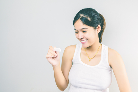 Young woman looking at pregnance test in happiness. new family concept. Vintage toneの写真素材