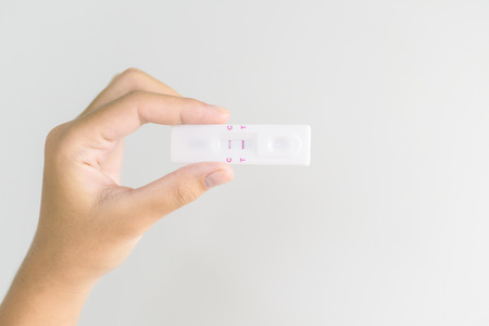 Woman holding pregnancy test. new family concept. Vintage tone