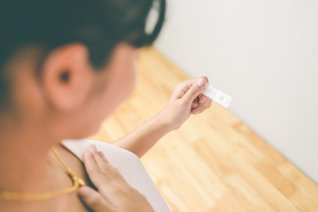Woman holding pregnancy test. new family concept. Vintage toneの写真素材