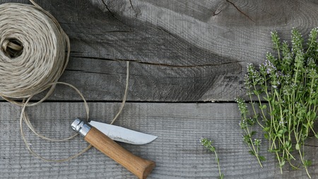 bundle of blooming thyme on old wood backgroundの写真素材