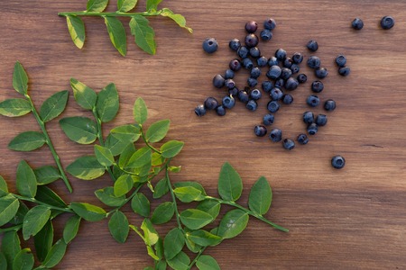 fresh blueberry with leafs on wooden backgroundの写真素材
