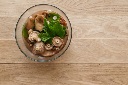 pickled milk mushrooms in the plate on woodの写真素材