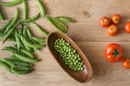 fresh farmer's harvest in the kitchen on wood backgroundの写真素材