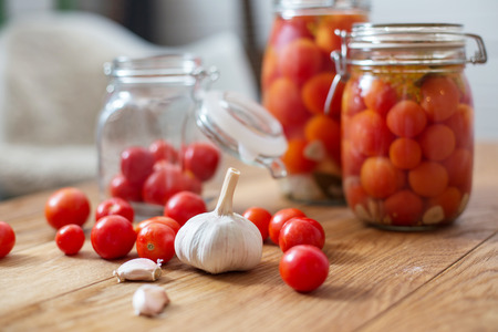 pots of marinated tomatoes and other ingredientsの写真素材