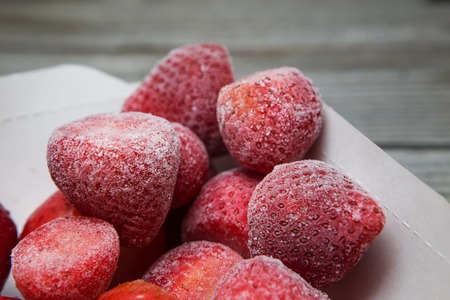 horisontal frozen berries with natural wooden backgroundの写真素材