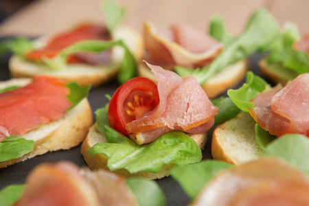sandwiches with salmon and beef in daylightの写真素材