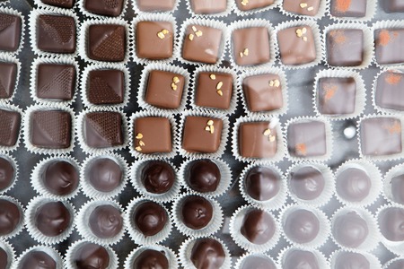 showcase with assorted chocolate candies in daylight