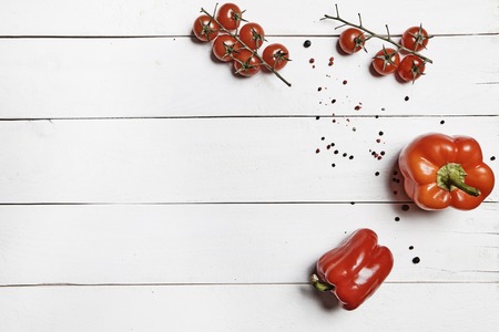 cherry tomatoes and paprika on white tableの写真素材