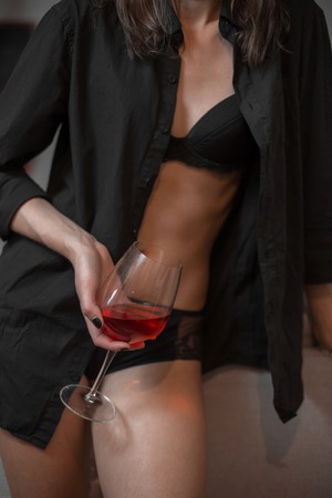 glass of rose wine in drunk woman's handの写真素材