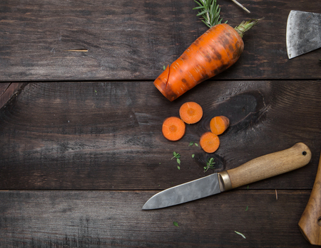 sliced carrot and knife on wood table in the kitchenの写真素材