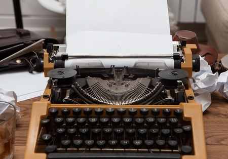 paper in old typewriter on wood tableの写真素材