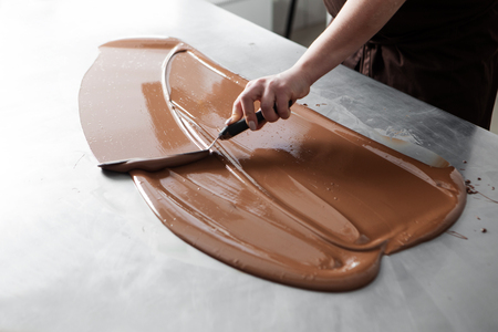 manufacturing of handcrafted chocolate candies in daylightの写真素材