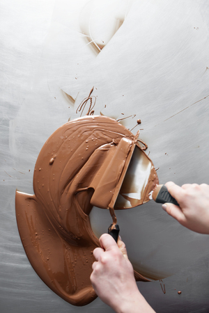 manufacturing of handcrafted chocolate candies in daylightの写真素材