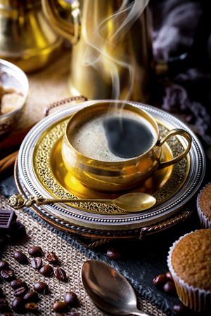 Black coffee in a cup on old backgroundの写真素材