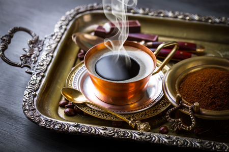 Coffee in a cup on old backgroundの写真素材