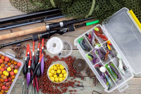 fishing tackle on a wooden table. toned image