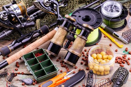 fishing tackle on a wooden table. toned imageの写真素材