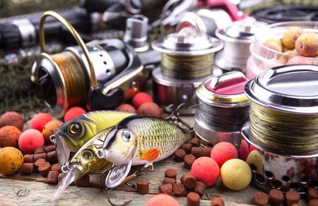 fishing tackle on a wooden table. toned imageの写真素材