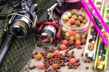 fishing tackle on a wooden table. toned image