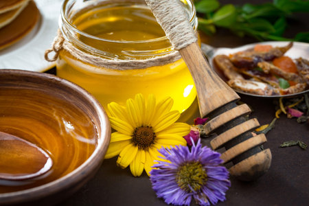 Sweet honey with flowers on an old background.の写真素材