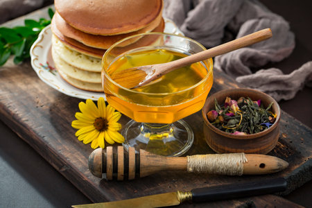 Sweet honey with flowers on an old background.の写真素材
