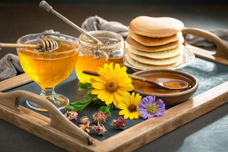 Sweet honey with flowers on an old background.の写真素材