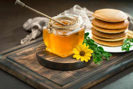 Sweet honey with flowers on an old background.の写真素材