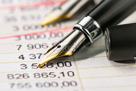 Close up of fountain pen on financial report. Business and finance concept.の写真素材