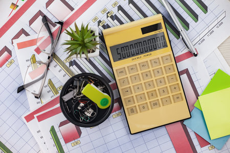 Close-up Of Businessman's Desk With Calculator And Stationeryの写真素材