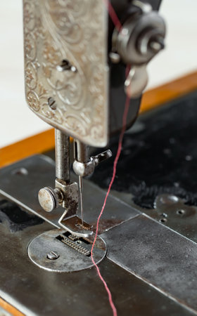 Sewing machine with red thread close-up. Sewing processの写真素材